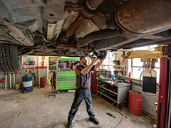 Kearney Tire & Auto Service | Mechnic under the car